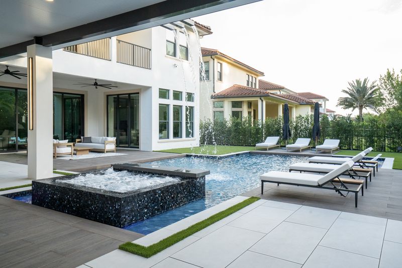 Custom spa spilling into a Liquid Luxe pool