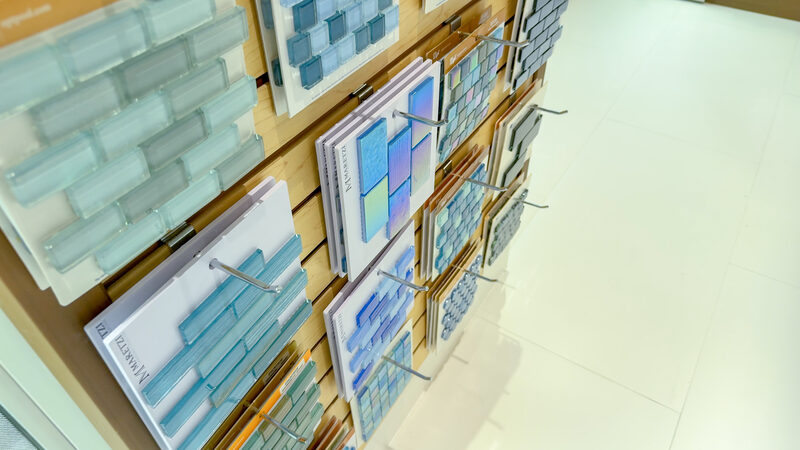 Iridescent glass pool tile samples on display at the showroom